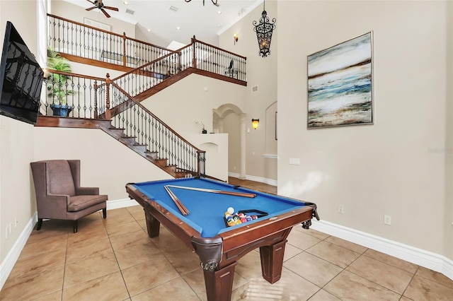 recreation room with ceiling fan, billiards, a towering ceiling, and light tile patterned floors