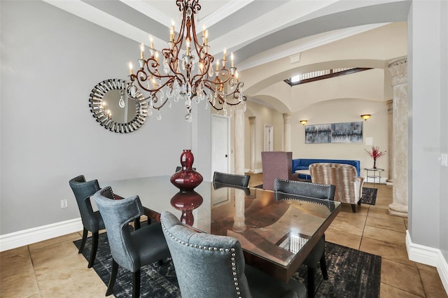 tiled dining space featuring a chandelier, decorative columns, and crown molding