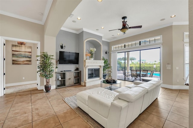 living room featuring light tile patterned flooring, ornamental molding, and ceiling fan