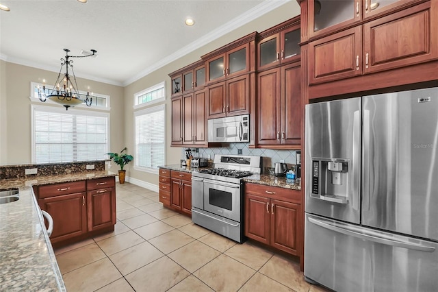 kitchen featuring light tile patterned floors, ornamental molding, decorative light fixtures, a chandelier, and appliances with stainless steel finishes