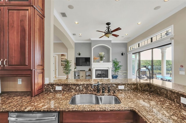 kitchen with ornamental molding, dishwasher, dark stone counters, and sink