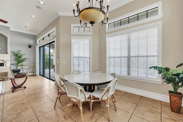 tiled dining room featuring a notable chandelier, crown molding, and a high end fireplace