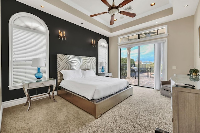 carpeted bedroom with ornamental molding, ceiling fan, a raised ceiling, and access to exterior