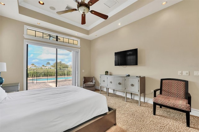 bedroom with carpet floors, access to outside, ceiling fan, and a raised ceiling