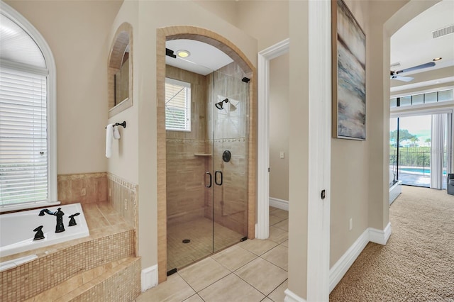 bathroom featuring shower with separate bathtub, tile patterned flooring, and ceiling fan