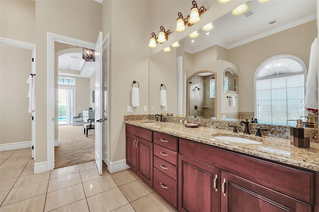 bathroom featuring vanity, crown molding, tile patterned flooring, and a shower with door