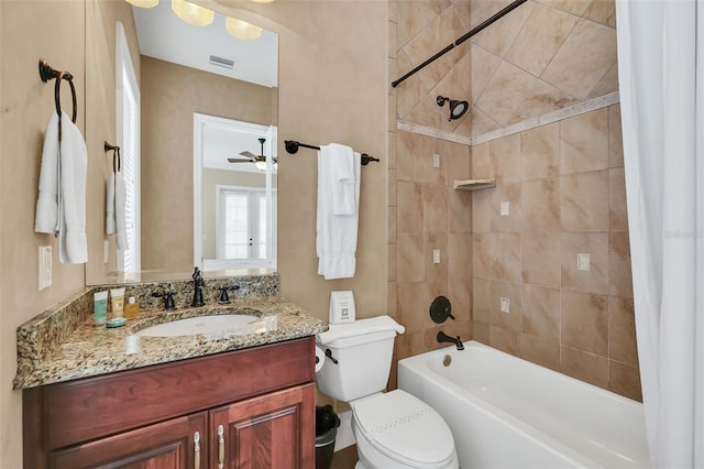 full bathroom featuring shower / tub combo, ceiling fan, vanity, and toilet