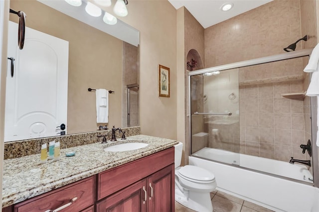 full bathroom with shower / bath combination with glass door, vanity, toilet, and tile patterned floors