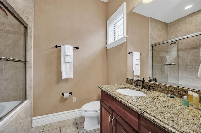 full bathroom featuring shower / bath combination with glass door, vanity, tile patterned flooring, and toilet