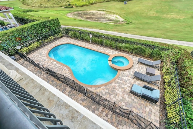 view of pool with a patio and an in ground hot tub