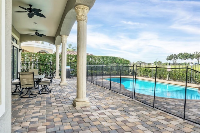 view of swimming pool featuring ceiling fan and a patio