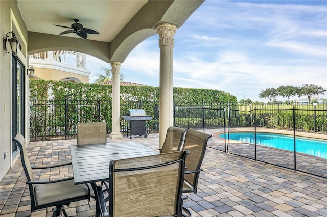 view of patio with ceiling fan, a fenced in pool, and a grill