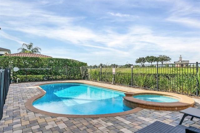 view of pool featuring an in ground hot tub and a patio area