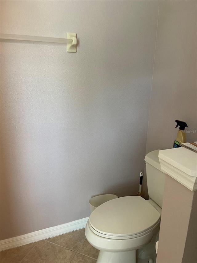 bathroom with tile patterned flooring and toilet