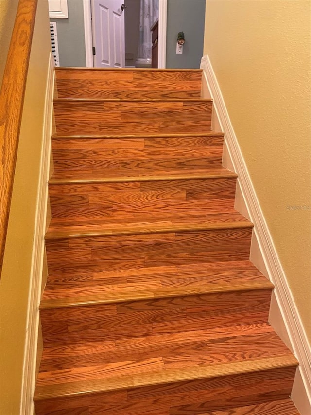 stairs with wood-type flooring