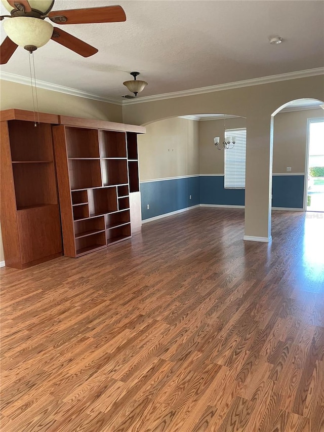 unfurnished living room with a textured ceiling, crown molding, ceiling fan with notable chandelier, and hardwood / wood-style flooring