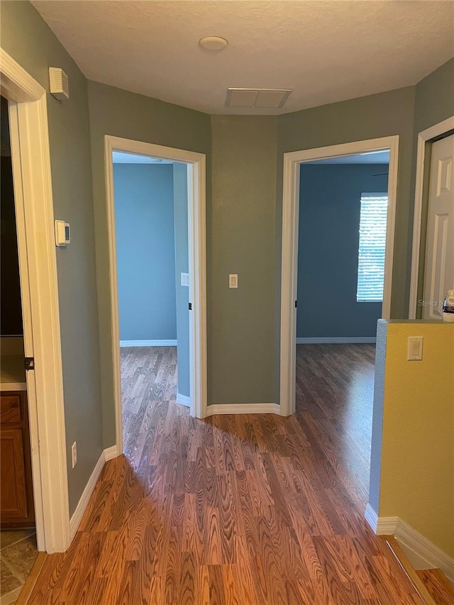 corridor featuring hardwood / wood-style floors