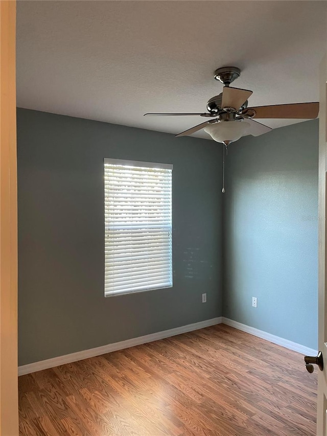 spare room with ceiling fan and hardwood / wood-style floors