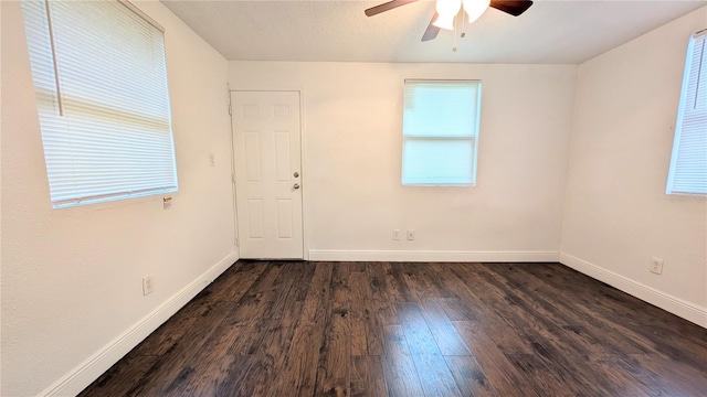 unfurnished room featuring dark wood-type flooring and ceiling fan