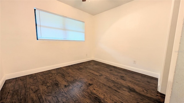 unfurnished room featuring dark wood-type flooring and ceiling fan