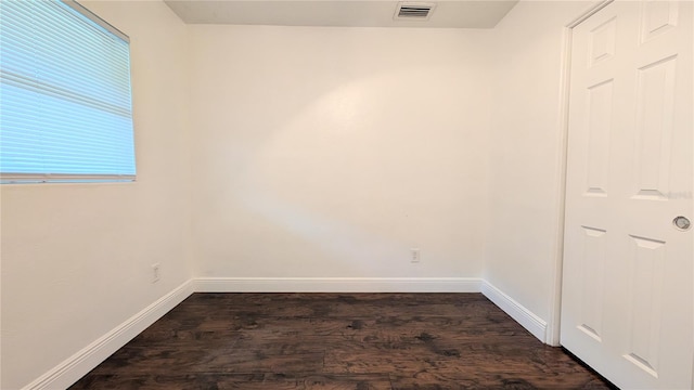 spare room with dark hardwood / wood-style floors