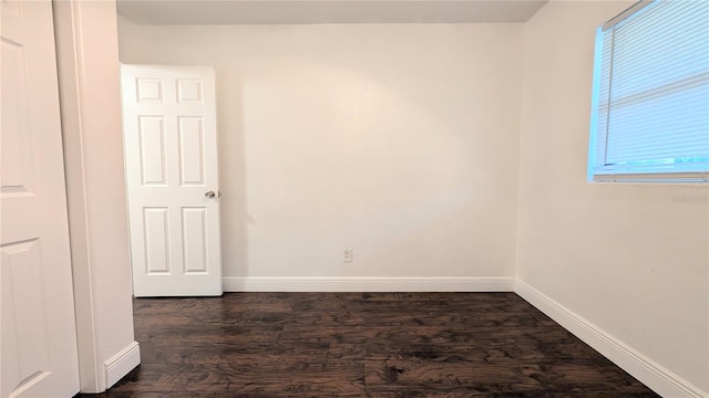 spare room with dark wood-type flooring