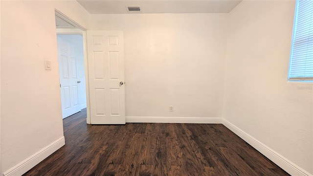 spare room with dark hardwood / wood-style flooring