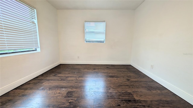 empty room featuring dark hardwood / wood-style flooring