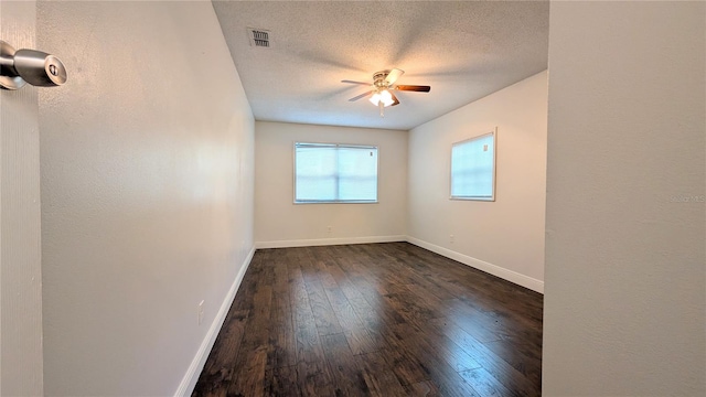 unfurnished room with dark wood-type flooring, ceiling fan, and a textured ceiling