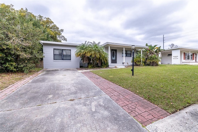 view of front facade with a front lawn and concrete driveway