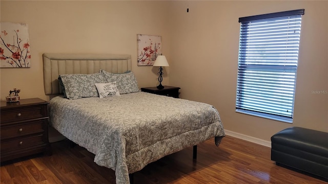 bedroom with dark wood-type flooring