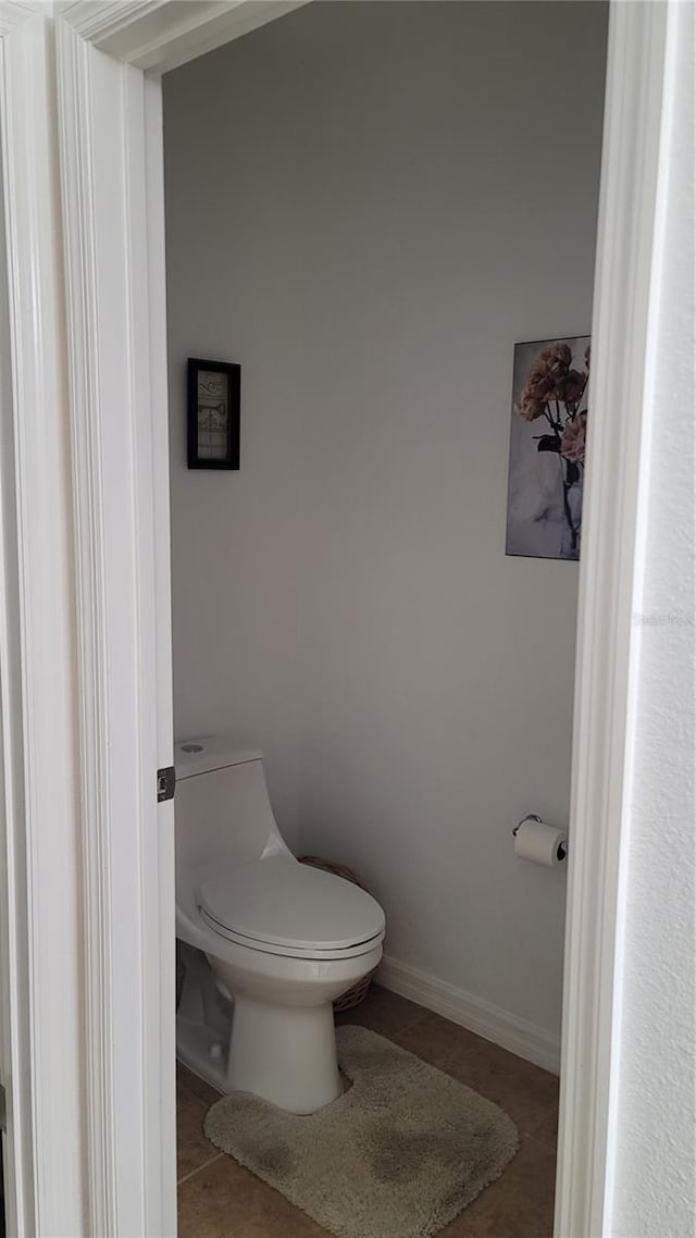 bathroom featuring toilet and tile patterned flooring