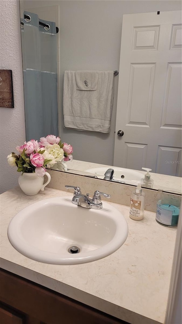 bathroom with vanity and curtained shower