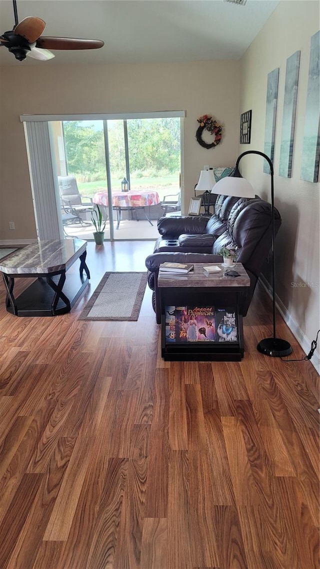 living room featuring hardwood / wood-style floors and ceiling fan