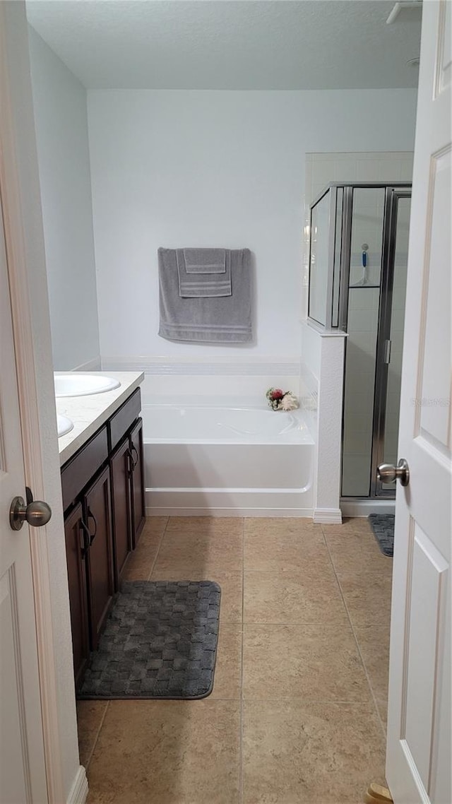 bathroom featuring vanity, independent shower and bath, and tile patterned flooring