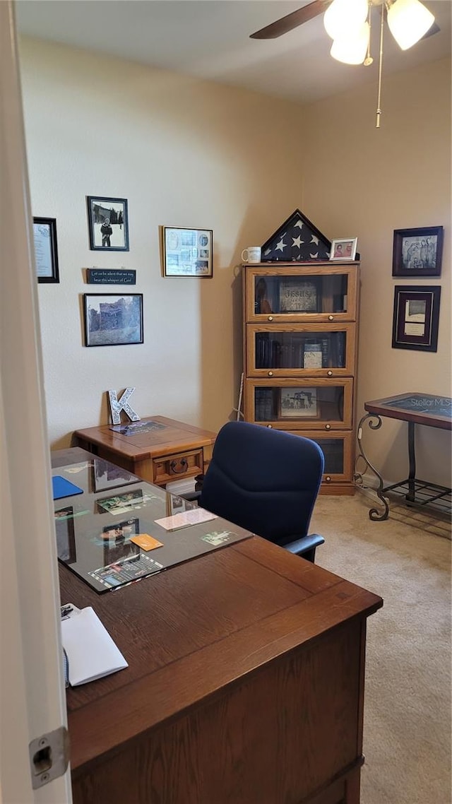 carpeted home office with ceiling fan