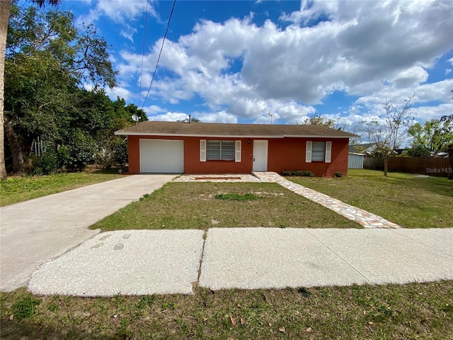 ranch-style home with a garage and a front lawn