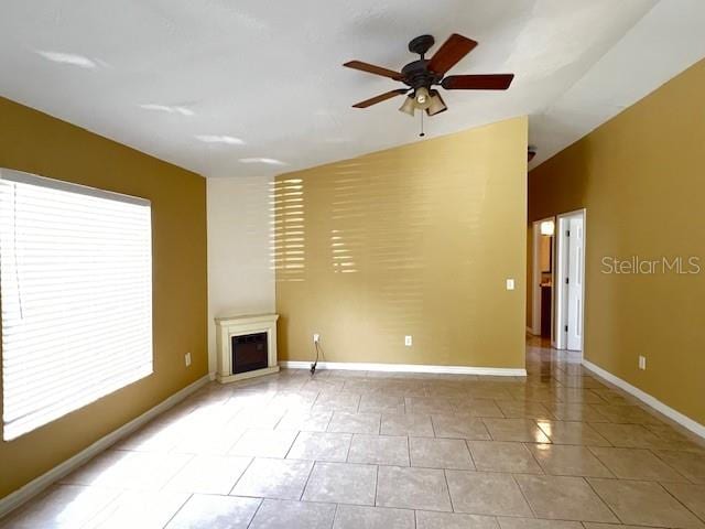 unfurnished living room with light tile patterned floors, vaulted ceiling, and ceiling fan