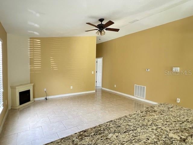 unfurnished living room with light tile patterned floors and ceiling fan