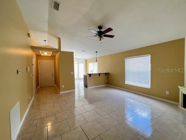 empty room featuring light tile patterned floors and ceiling fan