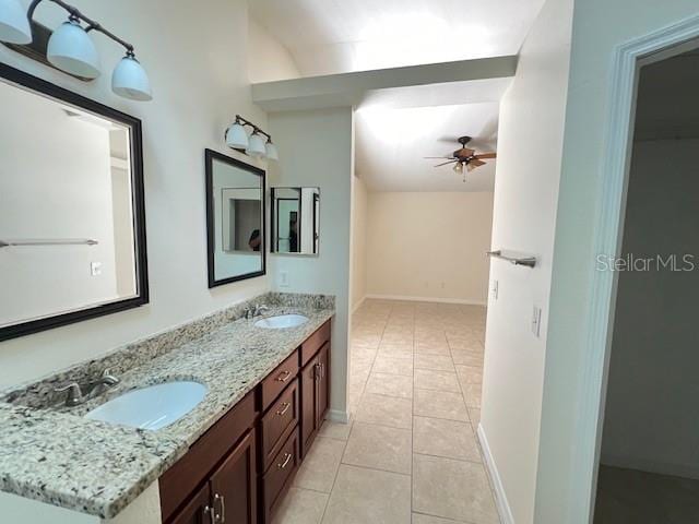 bathroom with lofted ceiling, tile patterned flooring, ceiling fan, and vanity