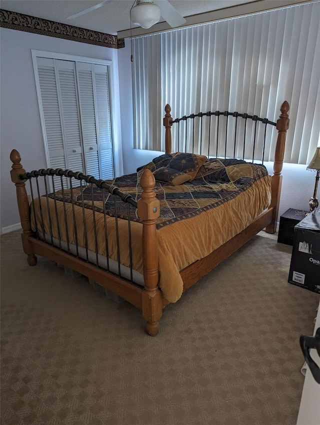 carpeted bedroom featuring a closet and ceiling fan