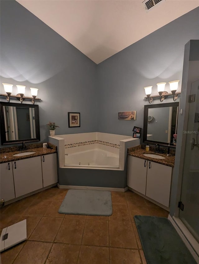 bathroom featuring a washtub, vanity, and tile patterned floors