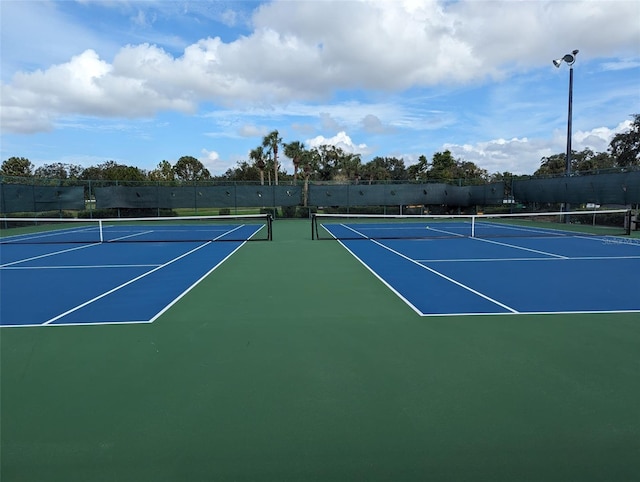 view of tennis court featuring basketball court