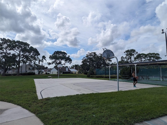 view of basketball court featuring a yard