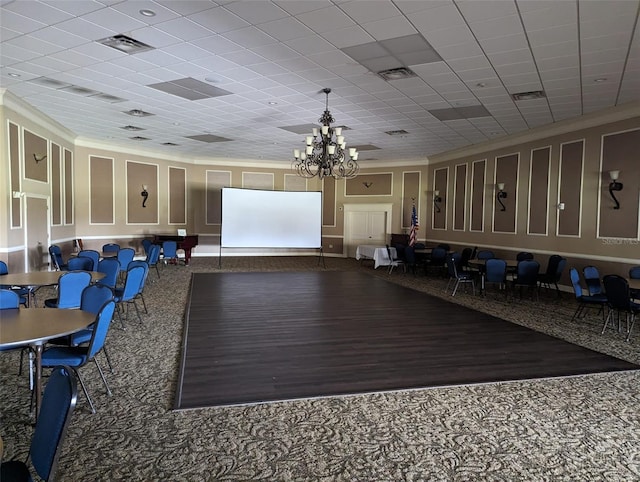 cinema room featuring crown molding and a notable chandelier