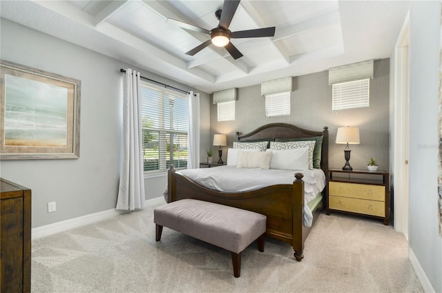 carpeted bedroom with a tray ceiling and ceiling fan