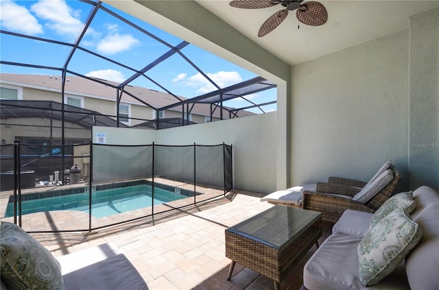 exterior space featuring ceiling fan, glass enclosure, and a patio