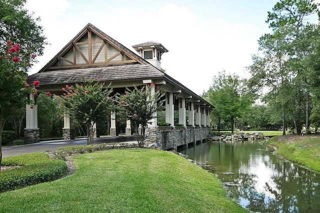 exterior space featuring a lawn and a water view