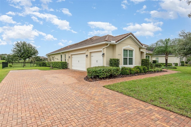 view of side of property with a garage and a lawn